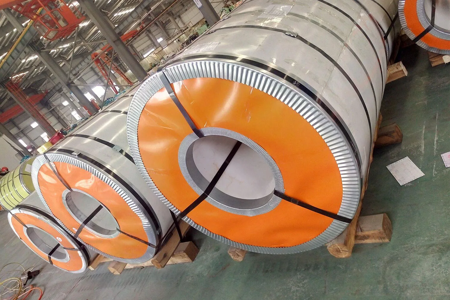 Close-up of multi-layer protective wrapping and strapping used in export steel coil packaging.