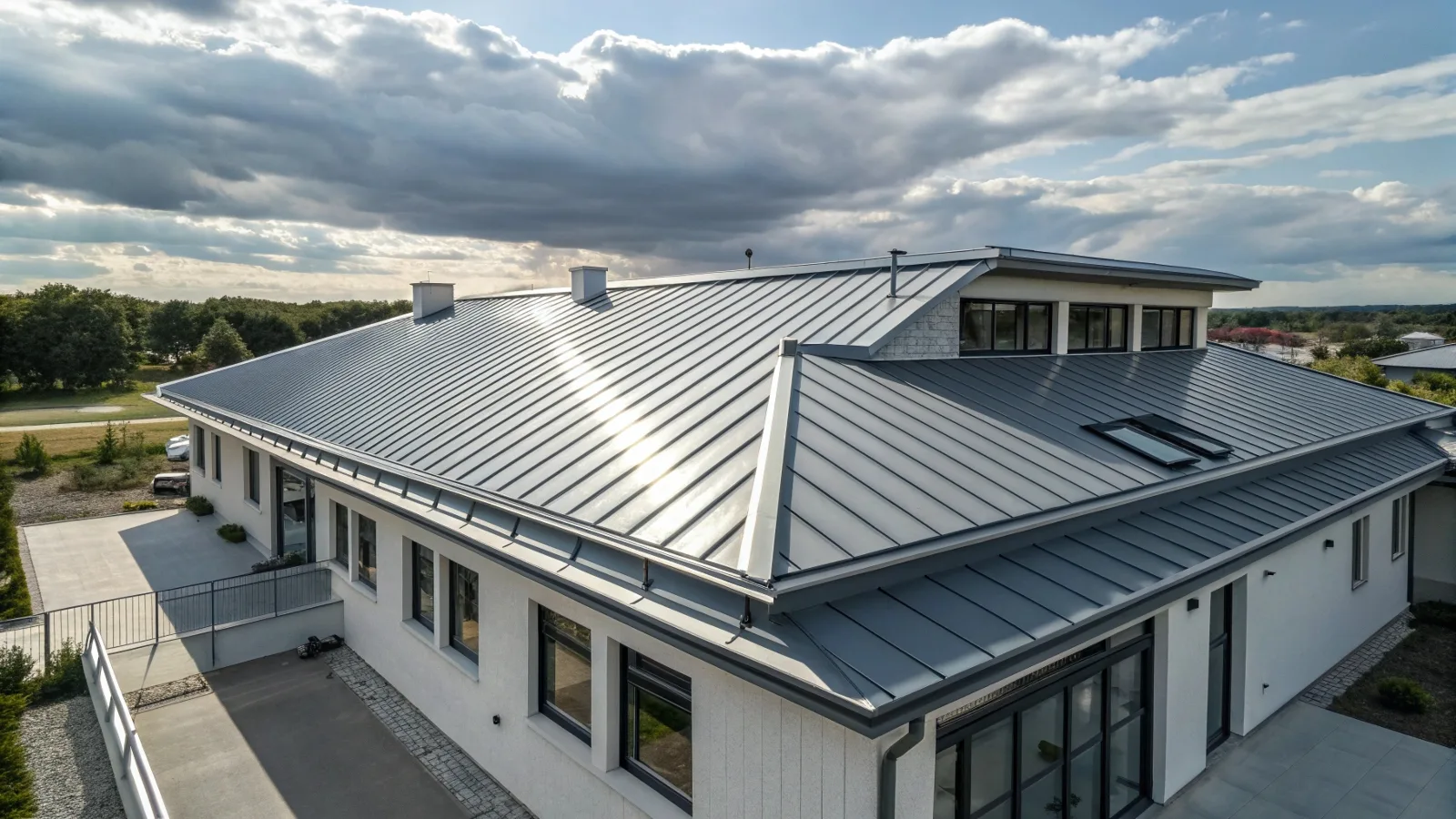 Modern building with a sleek steel roof reflecting sunlight, showcasing the beauty and durability of steel roofing materials.